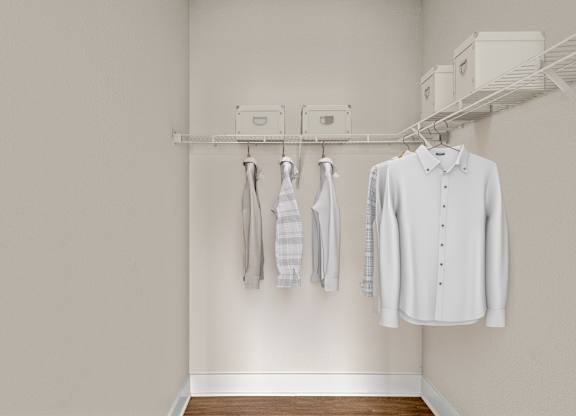 A white shirt hanging on a rack in a room.