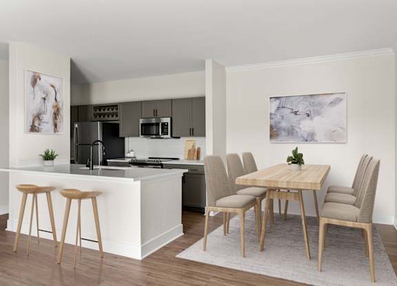 A kitchen with a bar and a dining table with chairs.