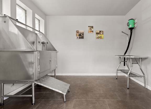 A room with a stainless steel table and a stainless steel oven.