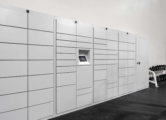 A wall of white lockers with a small door on the side.
