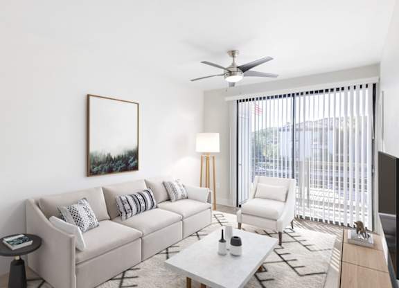 A living room with a white couch, a coffee table, and a painting on the wall.