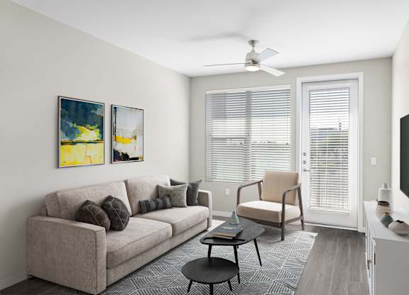 A living room with a couch, chair, and television.