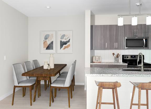 A kitchen with a dining table and chairs.