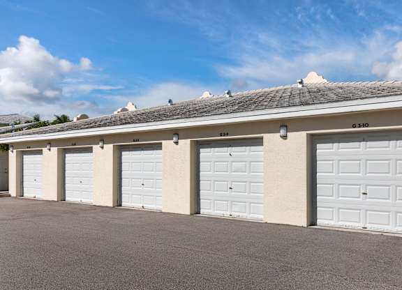 A row of white garage doors are closed.