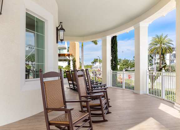 A row of chairs are on a patio.