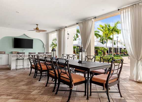 A dining room with a long table and chairs.