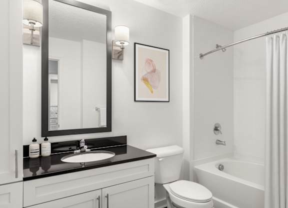 A bathroom with a white toilet and a white shower curtain.