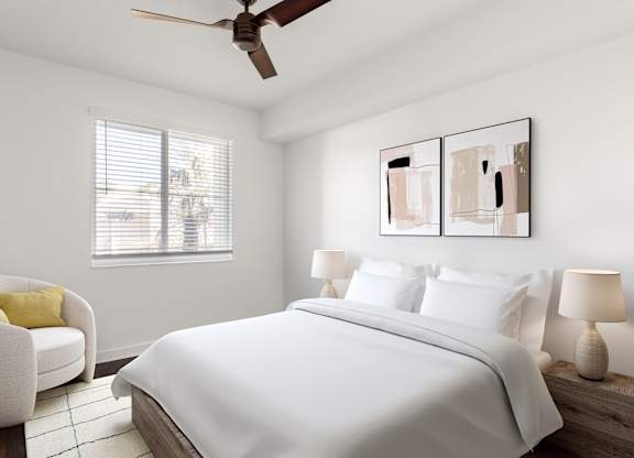 A bedroom with a large bed, a chair, and two lamps.
