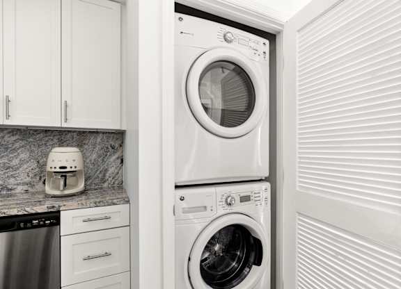 A white washing machine is in a laundry room.