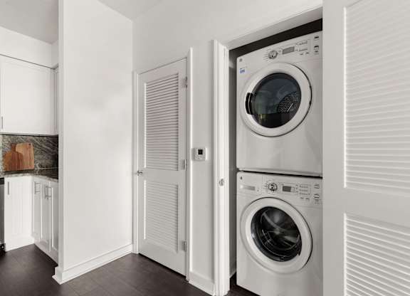 A white laundry room with a washer and dryer.