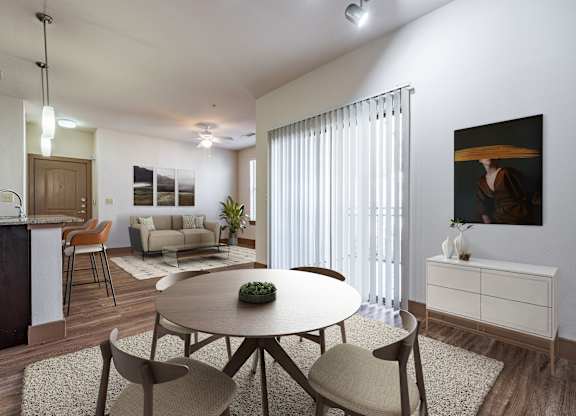 A modern dining room with a round table and chairs.