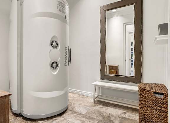 A white tankless water heater in a bathroom.