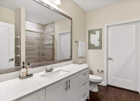 A bathroom with a white toilet and a white sink.
