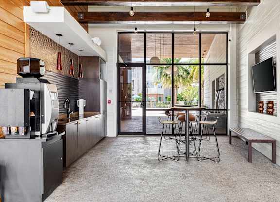 A modern kitchen with a dining table and chairs.