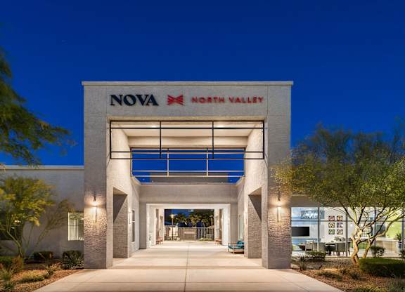 The entrance to the Nova North Valley building is shown at dusk.