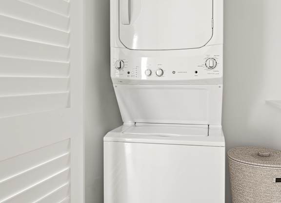 A white washing machine in a small room.