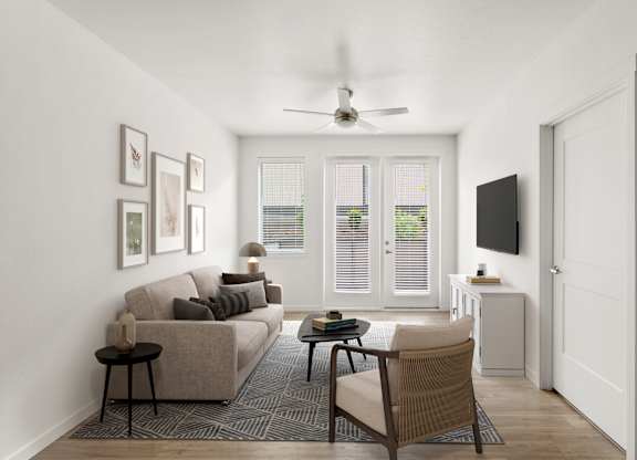 A living room with a couch, chair, and television.