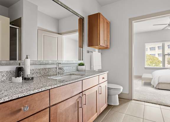A modern bathroom with a white sink and a mirror.