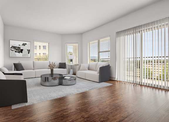 A modern living room with a large window and a view of the outside.