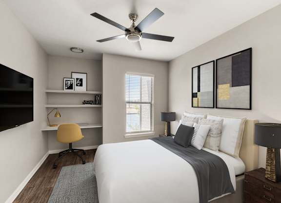 A bedroom with a bed, a desk with a chair, and a ceiling fan.