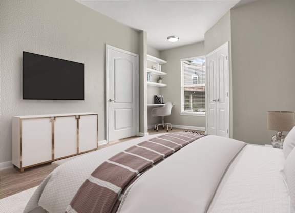 A bedroom with a large bed and a television on a cabinet.