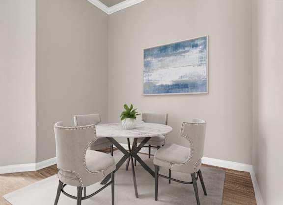 A dining room with a white table and chairs.
