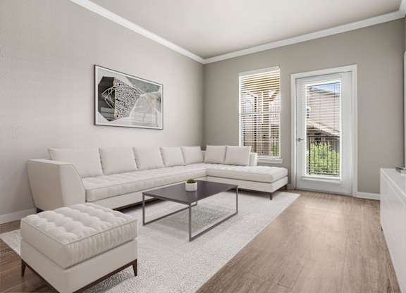 A modern living room with a white sofa, a coffee table, and a white ottoman.