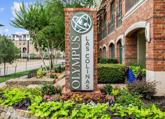 A sign that says Las Colinas in front of a building.