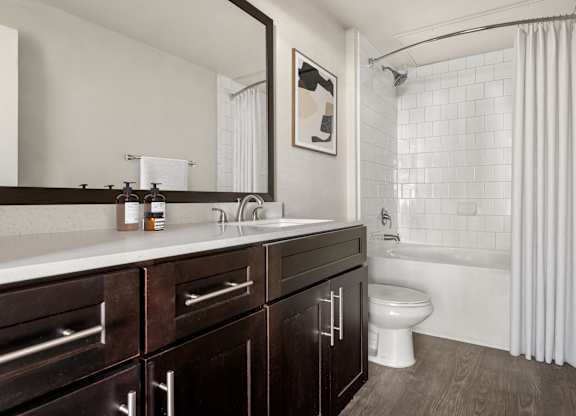 A bathroom with a white tub and a white toilet.