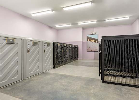A row of metal safe deposit boxes in a pink room.