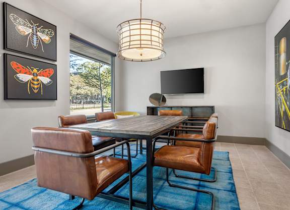 A modern dining room with a table and chairs.