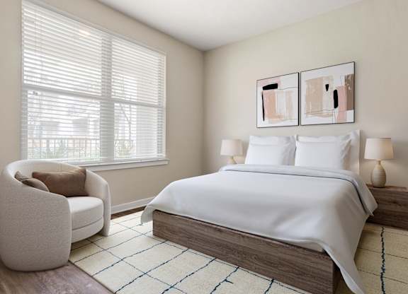 A bedroom with a large bed and a chair by the window.