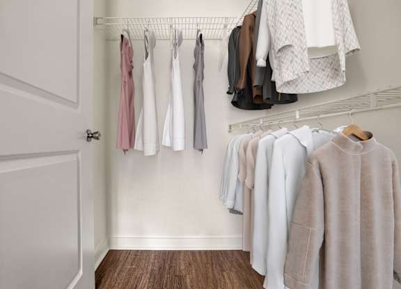 Clothes hanging on a rack in a room.
