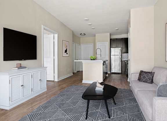 A living room with a black chair and a grey couch.