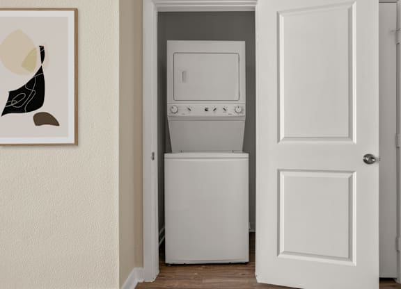 A white door is open to a laundry room.
