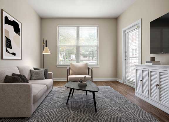 A living room with a couch, chair, and a painting on the wall.