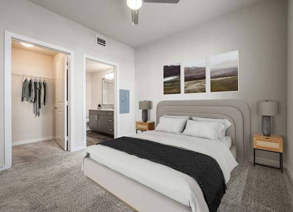 A bedroom with a large bed and a dresser with a mirror.