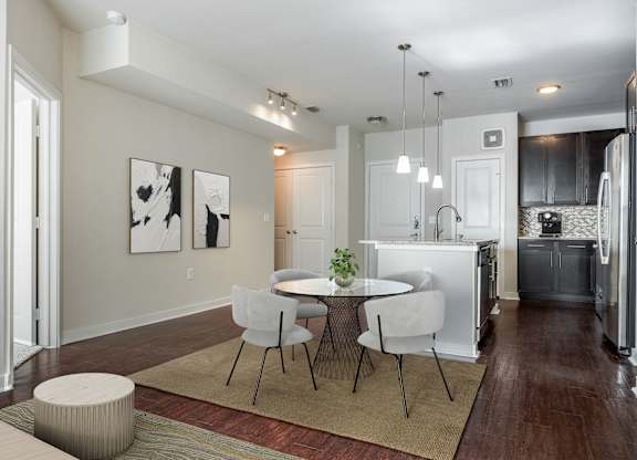 A modern kitchen with a dining table and chairs.