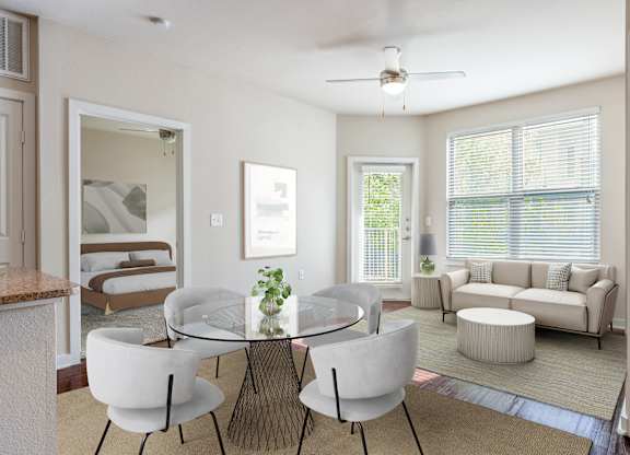 A modern dining room with a glass table and white chairs.
