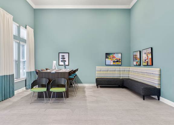A room with a dining table and chairs.