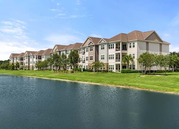 A large building with a lake in front of it.