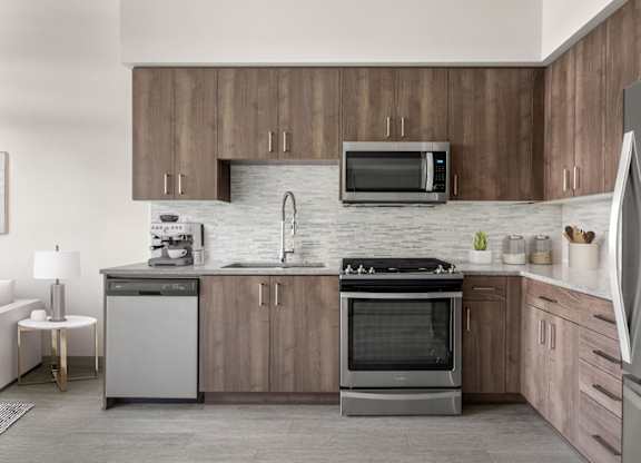 A modern kitchen with wooden cabinets and stainless steel appliances.