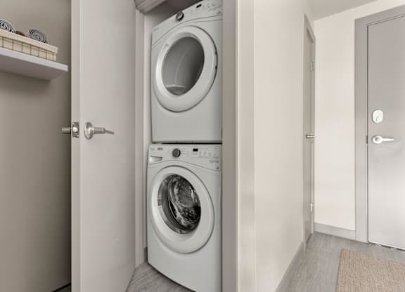 A white washing machine and dryer in a small laundry room.