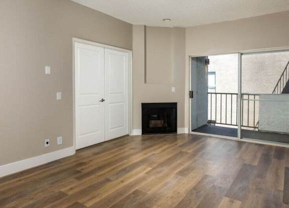 A room with a fireplace and a balcony.
