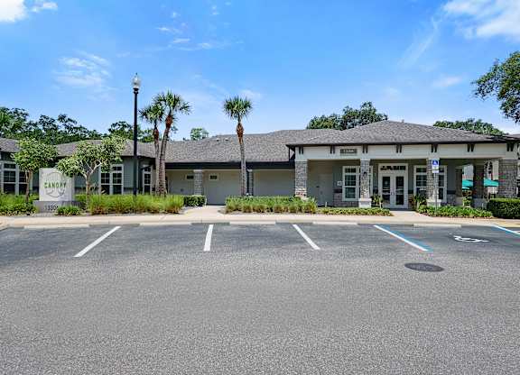A parking lot in front of a building with a sign that says "Campbell".