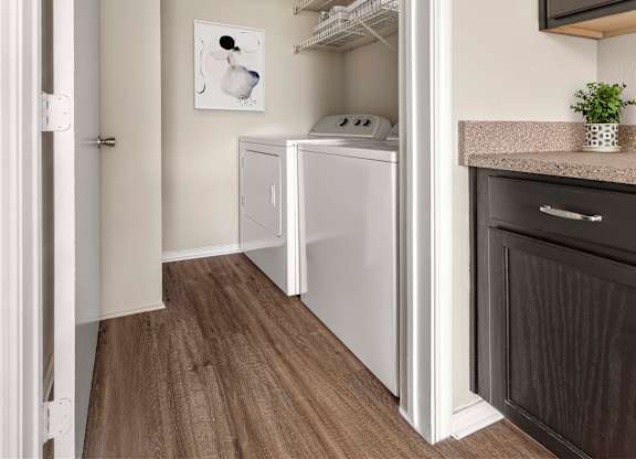 A small laundry room with a washer and dryer.