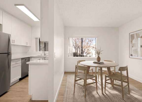 A kitchen with a table and chairs in the middle of the room.