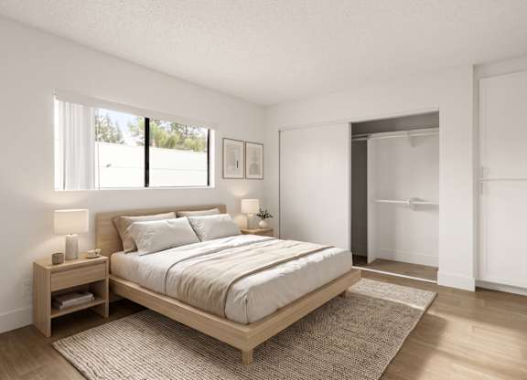 A bedroom with a large bed and a window.
