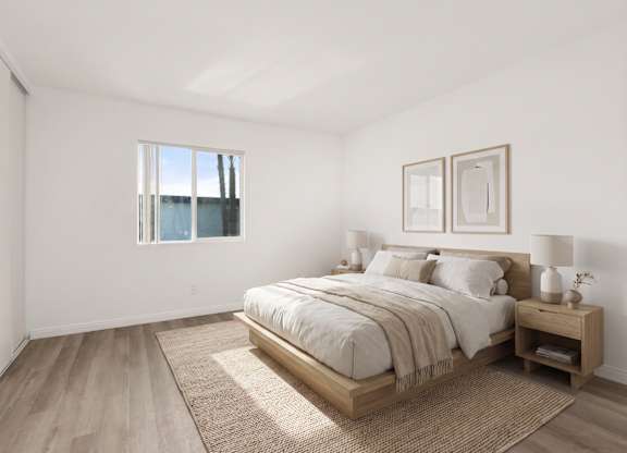 A bedroom with a large bed and a window.