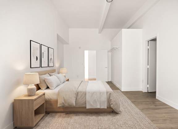 A bedroom with a bed, nightstand, and pictures on the wall.